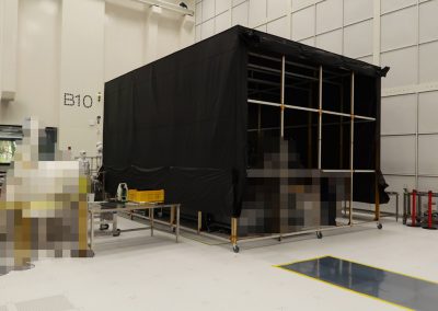 RF shielded blackout enclosure from the 8000 series with double-layer construction using Shieldex Berlin. The enclosure includes an extruded aluminum frame on casters, an internal frame system, roll-up wall, and skirting lift system depicted. This unit was custom designed to prevent light penetration.